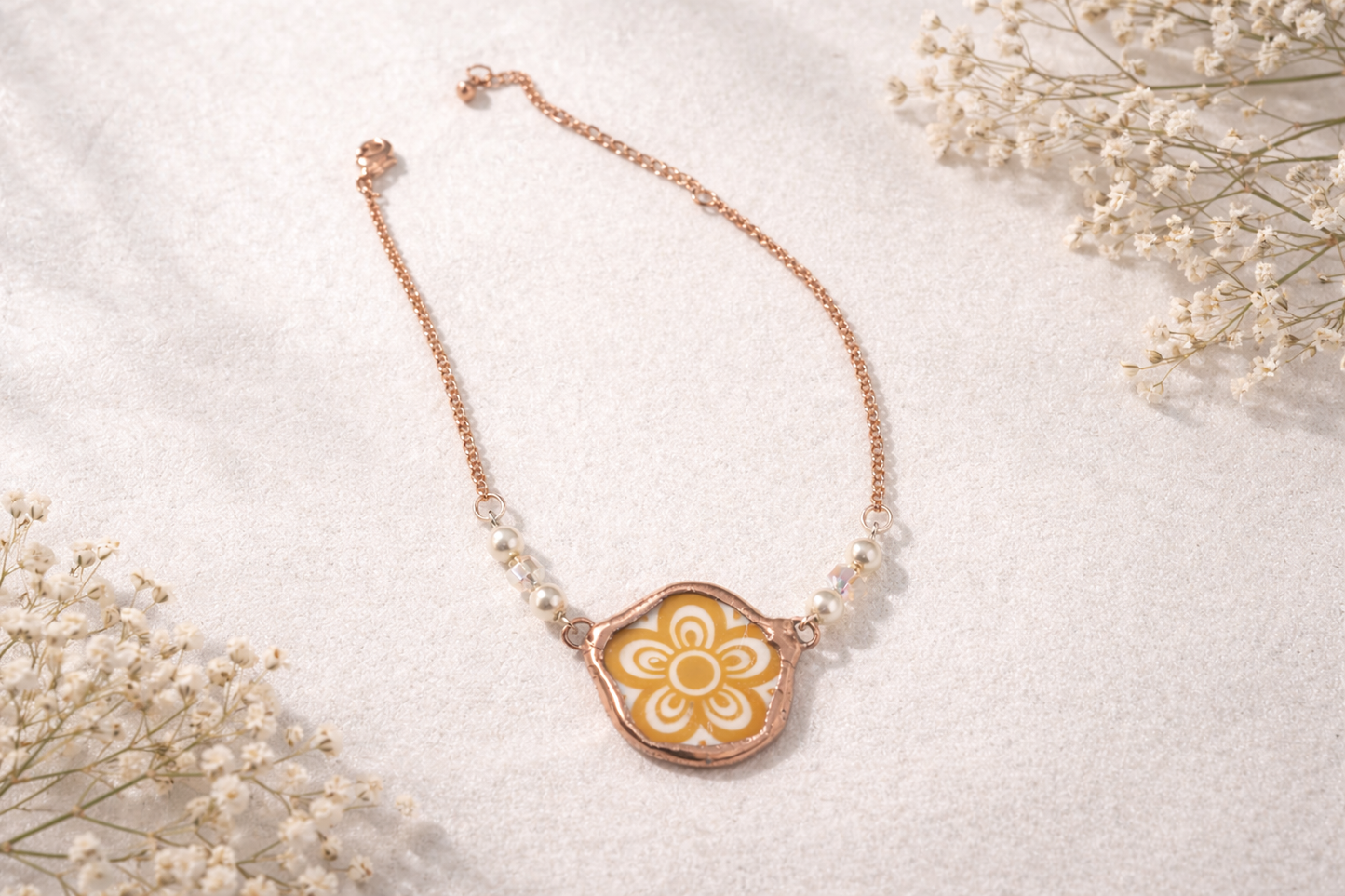 Necklace with a floral pendant on a light background
